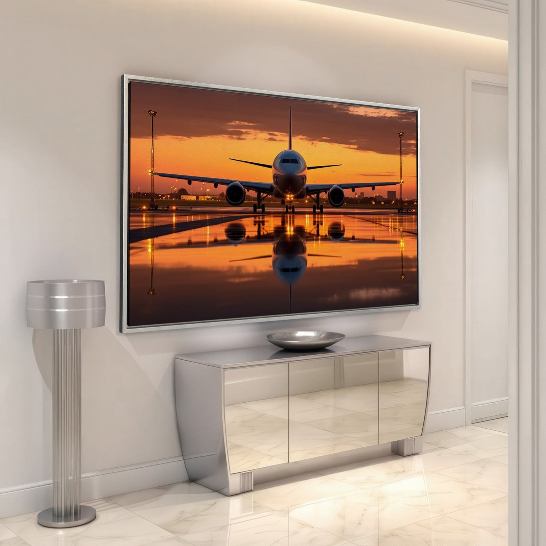 Framed Wall Art of a plane at sunset. Dramatic orange sky and reflective runway. Modern aviation art, perfect for home decor.