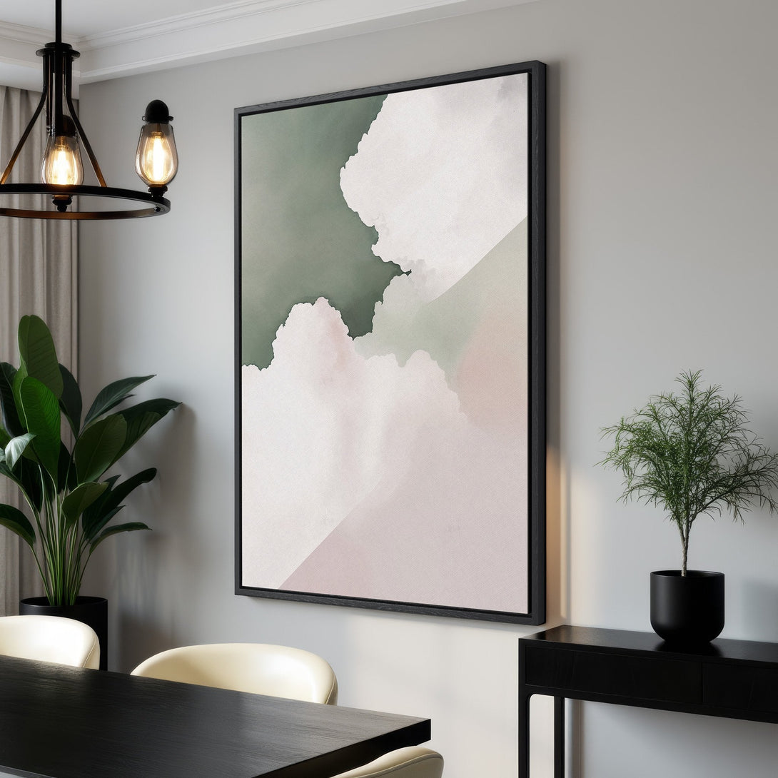 Framed Wall Art featuring abstract cloud-like shapes in a soft, muted green and pink color palette. Perfect for adding a touch of modern art to any space.