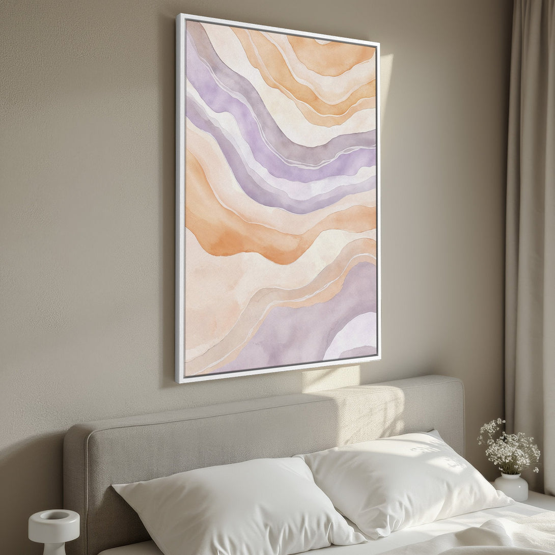 Framed Wall Art featuring an abstract watercolor design in soft peach and lavender tones. Perfect for adding a touch of elegance to any bedroom decor.