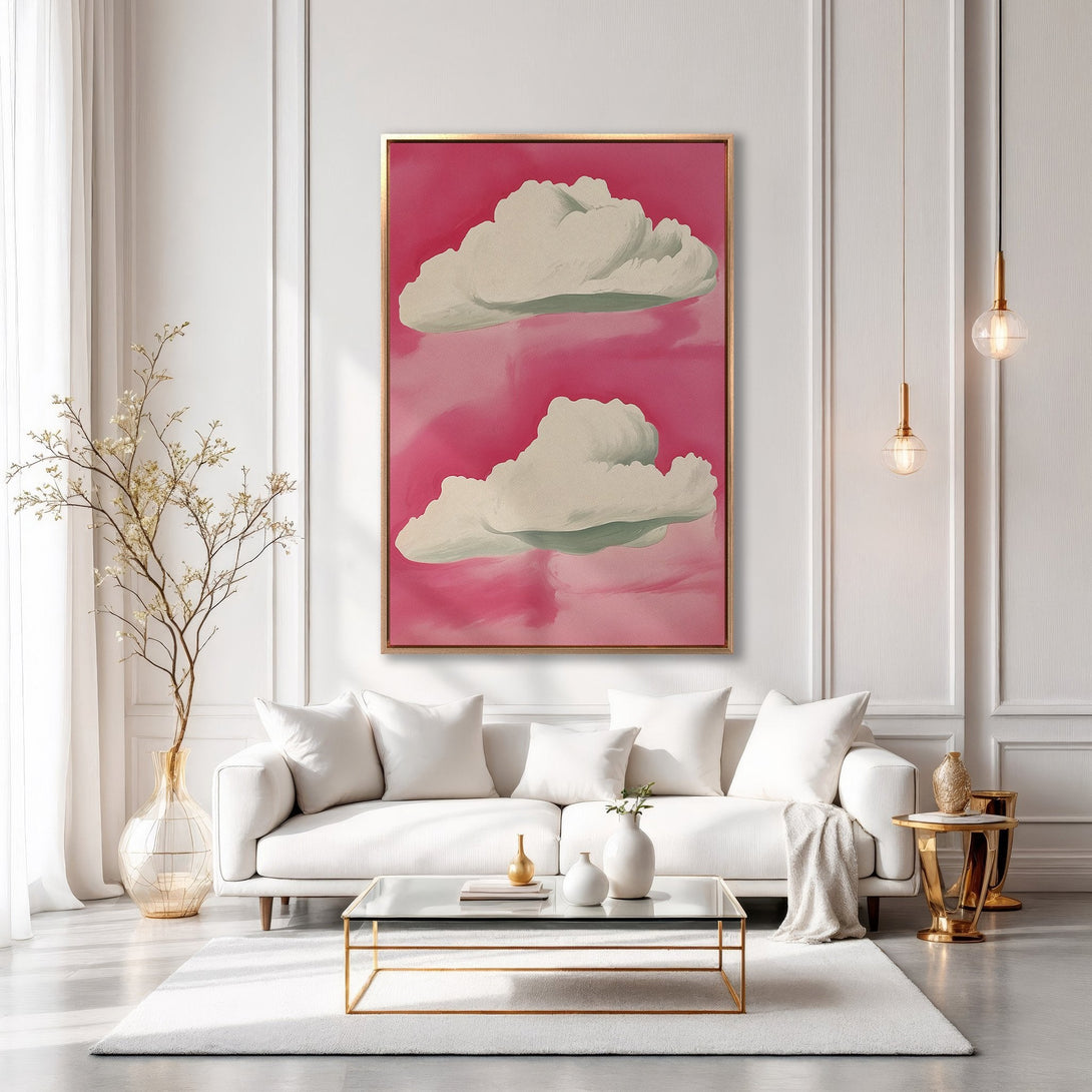 Framed Wall Art featuring whimsical cloud painting in pink and white. Modern style canvas print adds a pop of color to any living room.