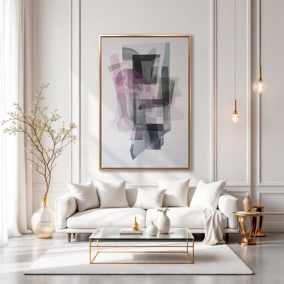 Framed Wall Art: Modern abstract art in a gold frame. Features a geometric design with pink, gray, and black hues. Elevate your living room decor.