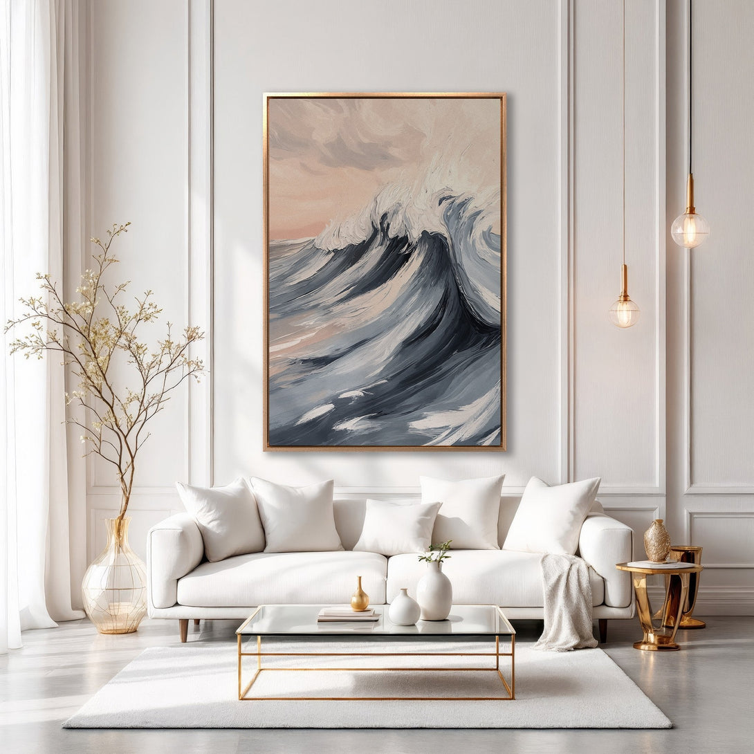 Framed Wall Art of a crashing wave in a modern living room. The painting features a blue, gray, and blush color palette, perfect for coastal decor.