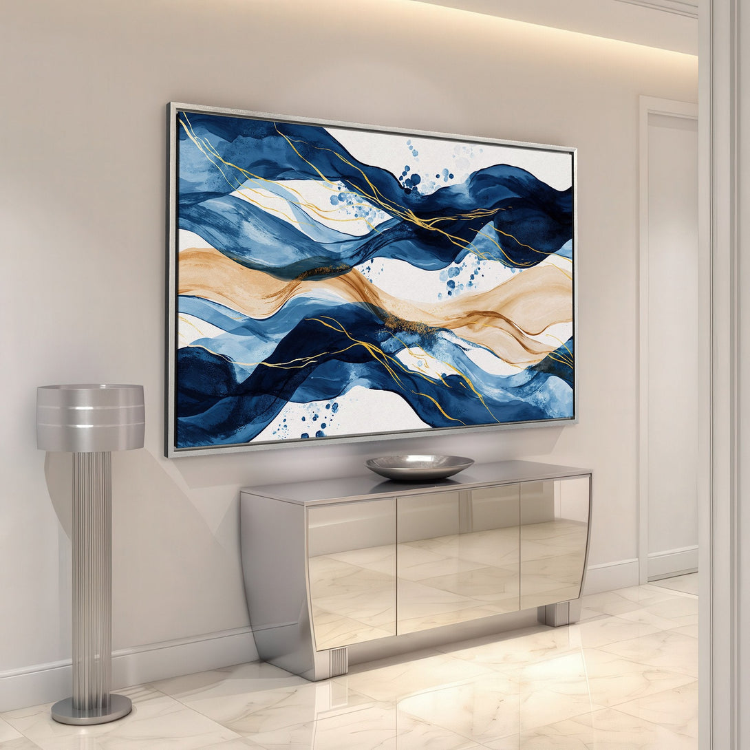 Framed Wall Art featuring abstract blue and gold waves. Modern Canvas Print for a stylish interior. Coastal-inspired art with a calming color palette.