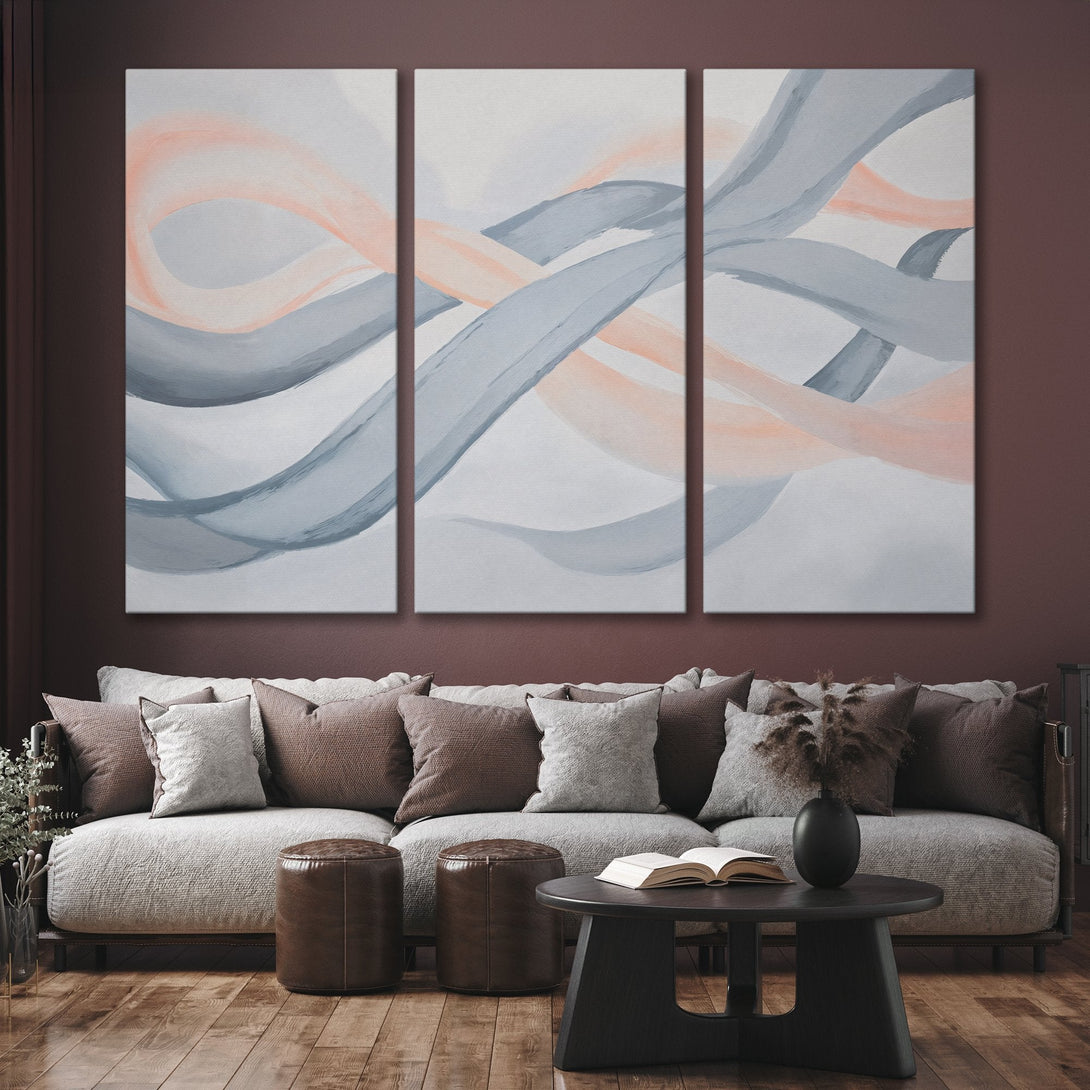Abstract Canvas Print art in a modern interior. Features flowing brushstrokes in gray and peach hues, perfect for adding a touch of elegance.