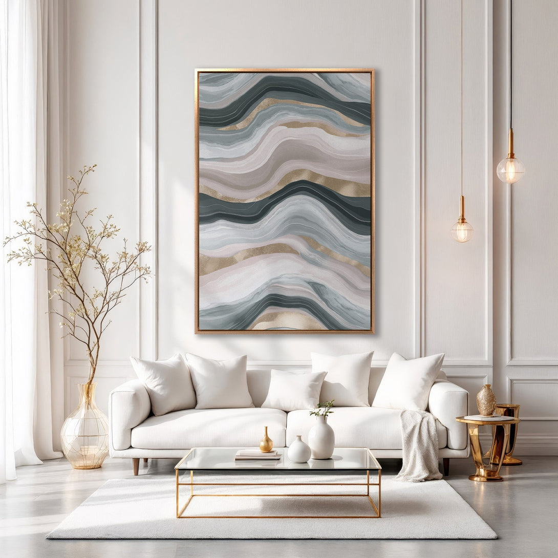 Abstract Canvas Print in a modern living room. Features a gold-framed artwork with flowing lines in muted blues, grays, and gold. Perfect for home decor.