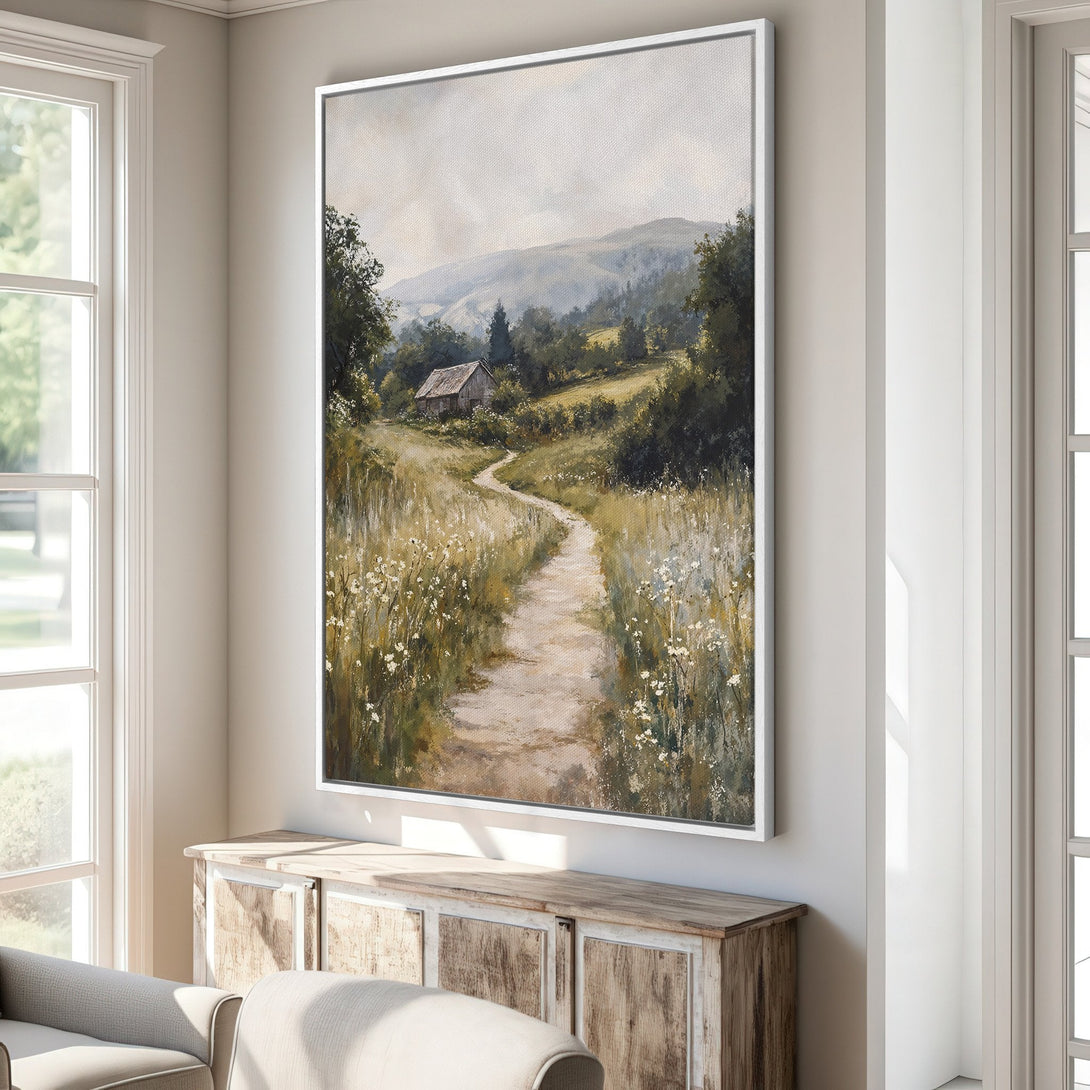 Framed Wall Art featuring a serene landscape painting with a path leading to a cabin. Earthy tones and a soft, impressionistic style enhance any space.