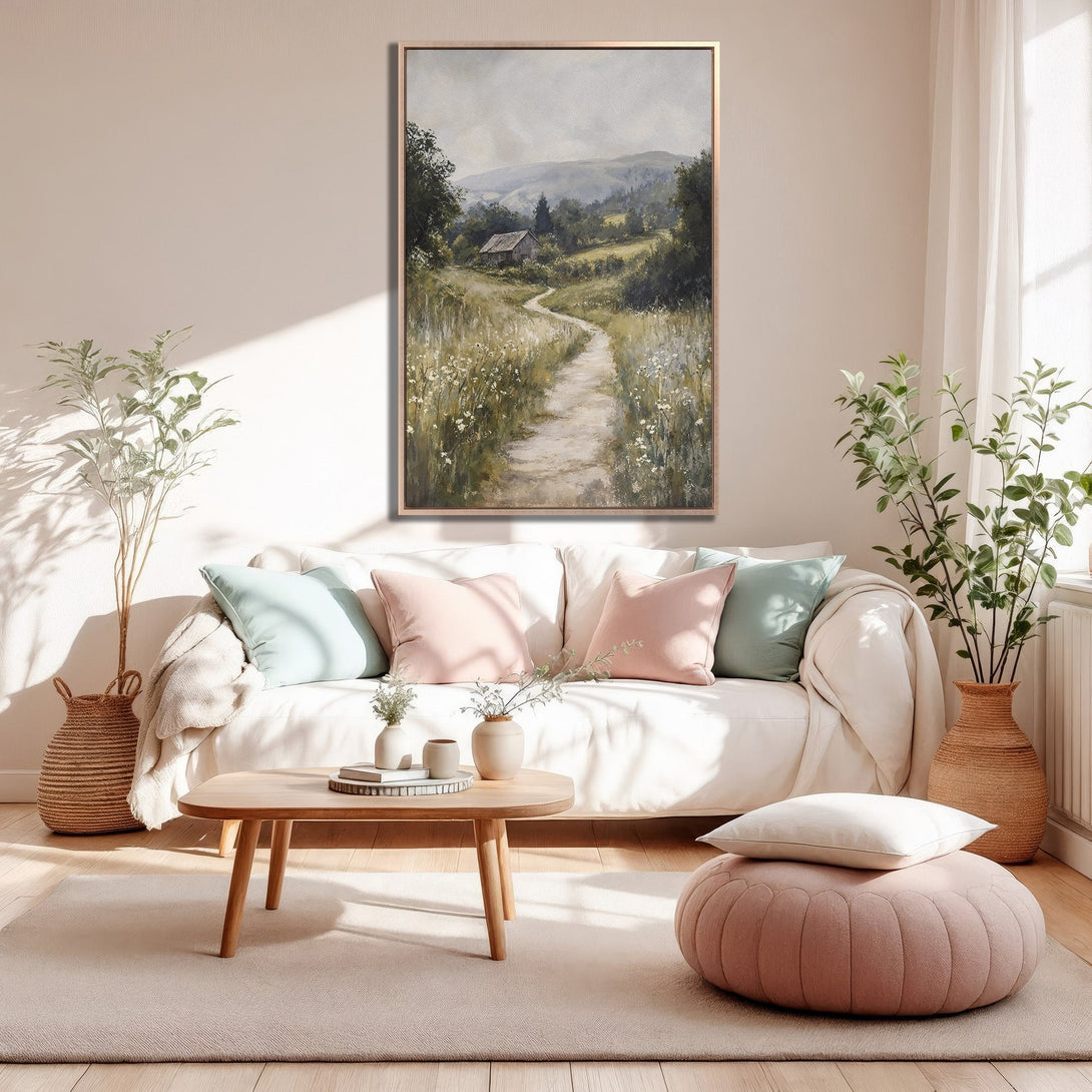 Framed Wall Art: Landscape painting in neutral tones. Serene path leads to a cabin. Earthy color palette complements the cozy interior.