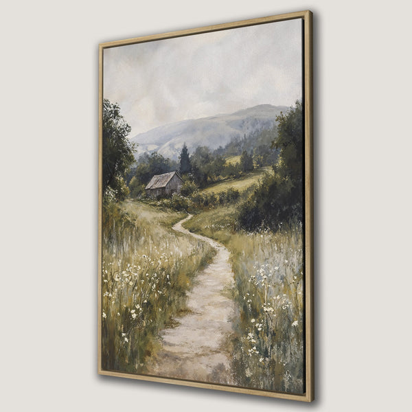 Framed Wall Art: Serene landscape Canvas Print featuring a winding path, cottage, and soft green/brown color palette, perfect for adding a touch of nature.