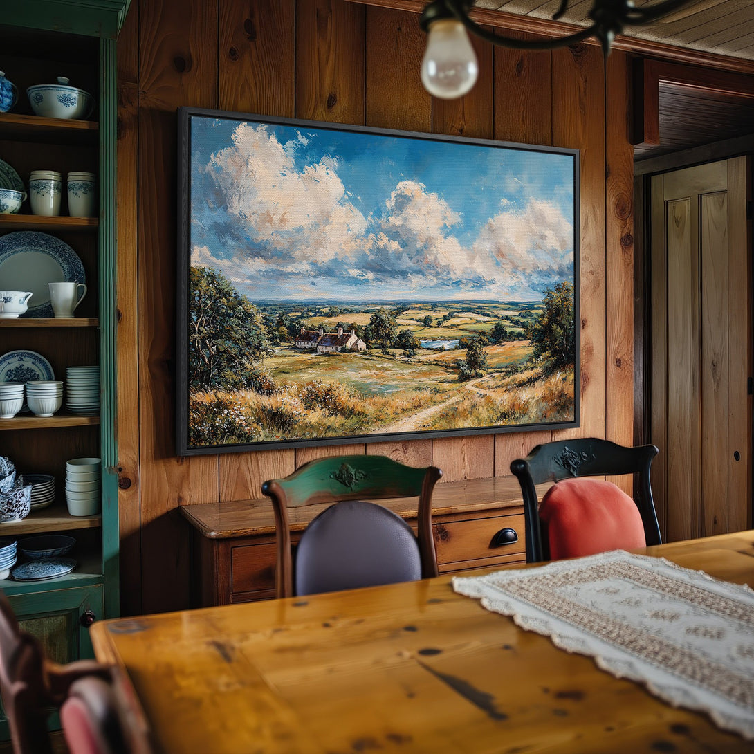 Framed Wall Art: Landscape painting with blue sky and fields, displayed in a cozy dining room. Warm color palette, perfect for home decor.