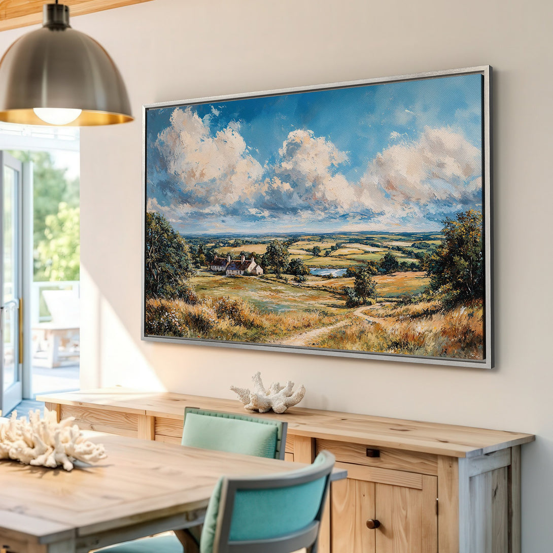 Framed Wall Art: Landscape Canvas Print. Impressionist style painting of a rural scene with blue skies, green fields, and warm tones. Perfect home decor.