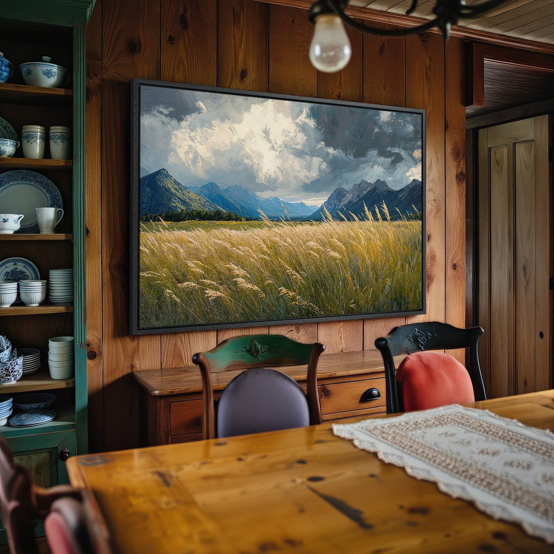 Framed Wall Art: Landscape Canvas Print with mountains, fields, and dramatic sky. Earthy tones of green, gold, and blue create a serene, rustic aesthetic.