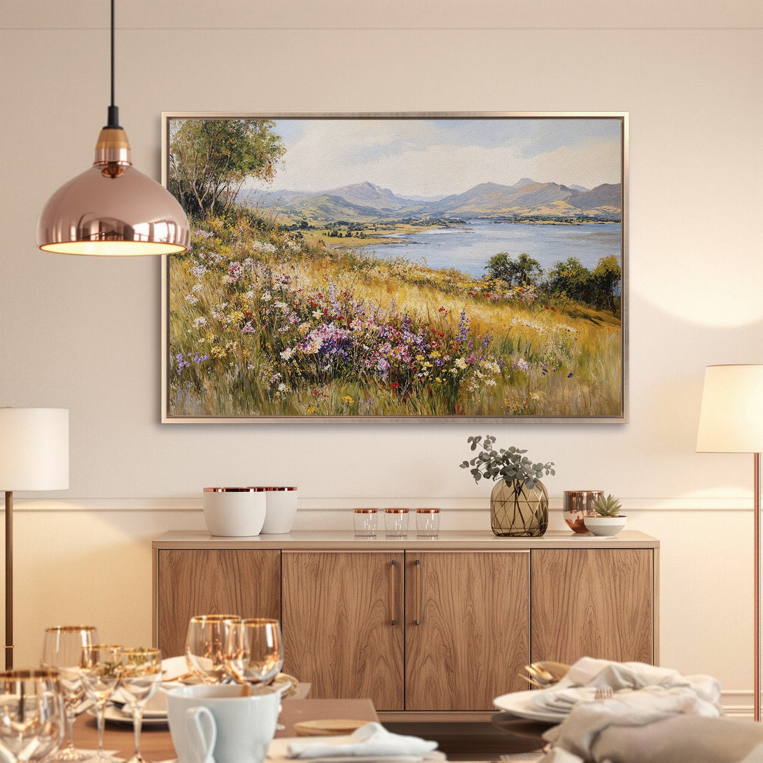 Framed Wall Art: Landscape painting with vibrant wildflowers, lake, and mountains. Earthy tones and a touch of blue create a serene, natural aesthetic.