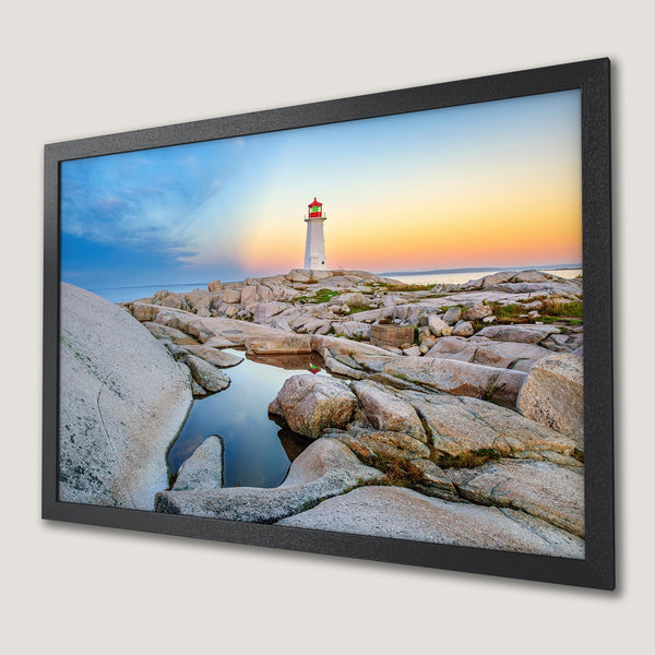 Framed Poster featuring a lighthouse at sunset. Coastal landscape art with warm orange, blue, and gray tones. Bring the beauty of nature home!