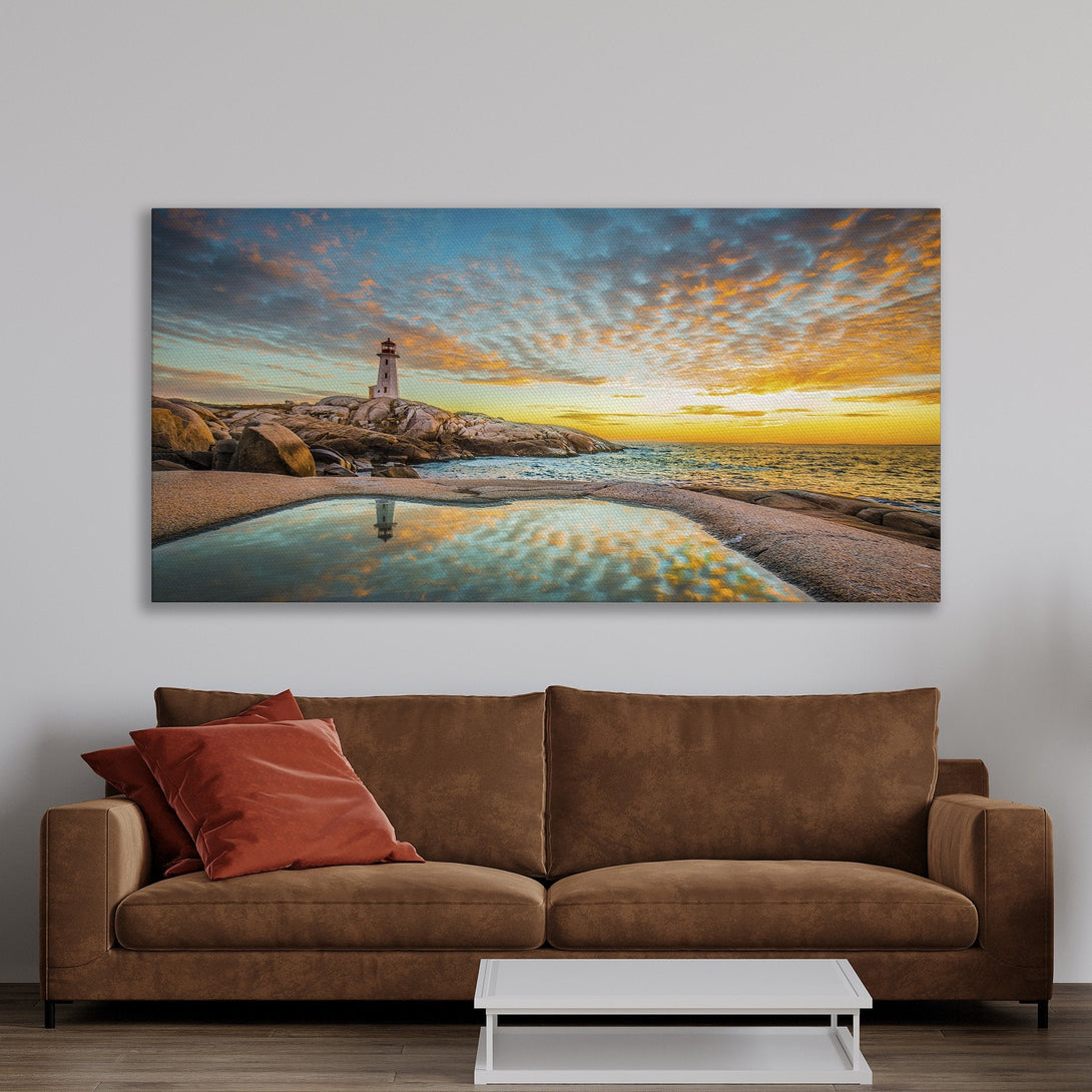 Framed Wall Art of a lighthouse at sunset. Coastal landscape art with vibrant blue, orange, and yellow hues. Perfect for adding a touch of serenity to your home.