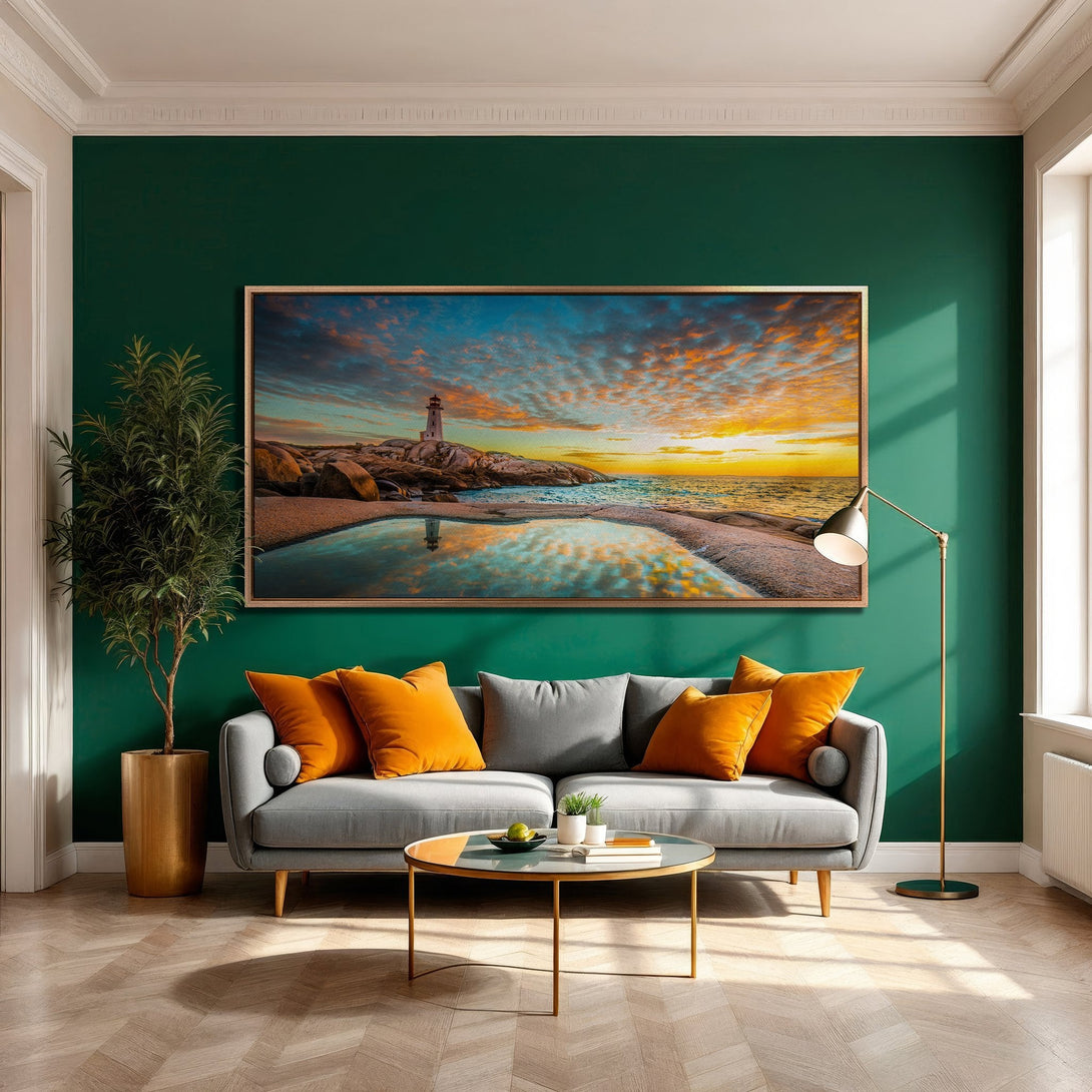Framed Wall Art of lighthouse at sunset. Coastal landscape art with warm sunset and cool blue hues, displayed in a modern living room.