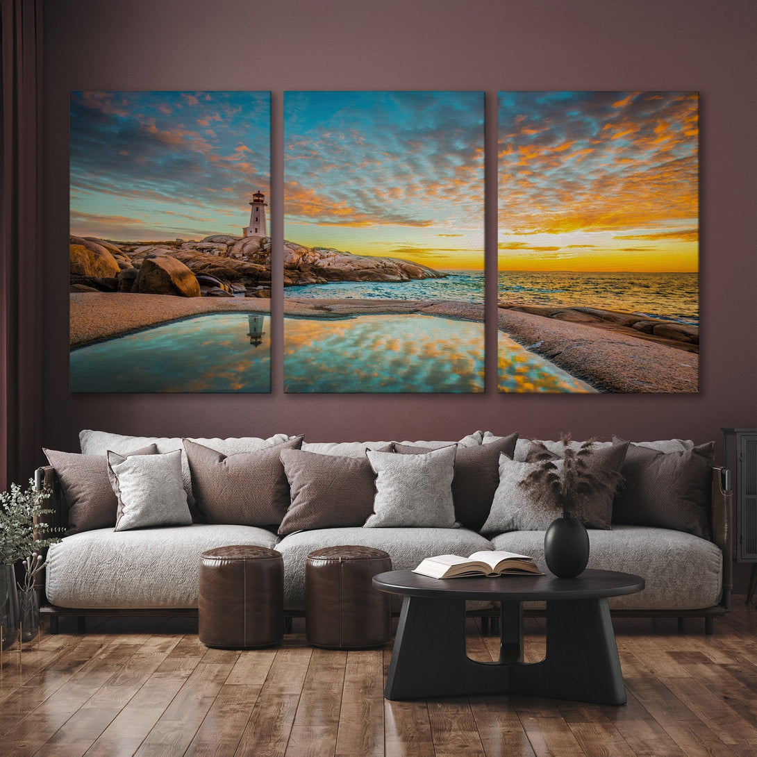 Canvas Print of a lighthouse at sunset, vibrant blues and oranges. Coastal landscape art, perfect for living room decor.