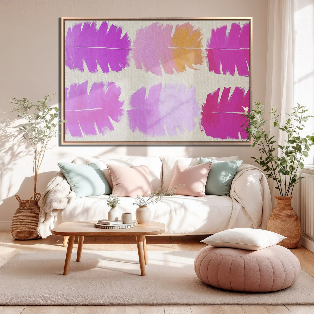 Framed Wall Art: Abstract brushstroke art in pink and gold hues. Modern canvas print adds color and style to a living room interior.