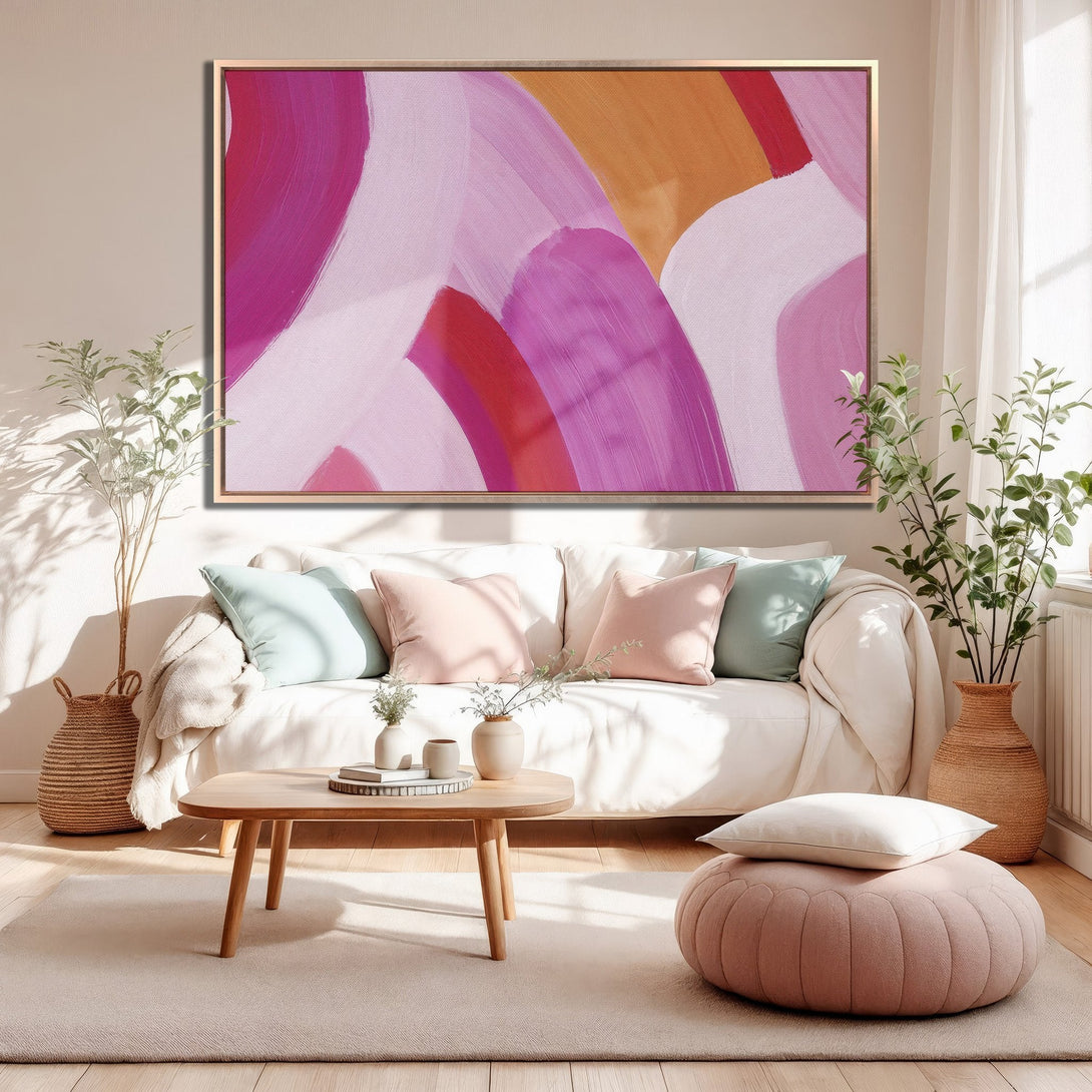 Framed Wall Art featuring abstract brushstrokes in pink and orange hues, displayed in a modern living room. Perfect for adding a pop of color!