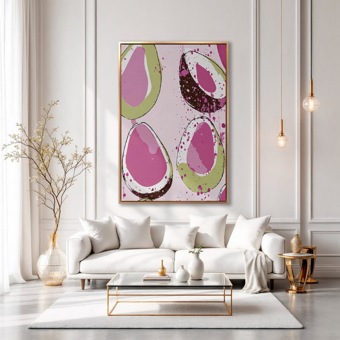 Framed Wall Art featuring abstract avocado slices in pink, green, and brown. Modern art canvas print adds a pop of color to a minimalist living room.