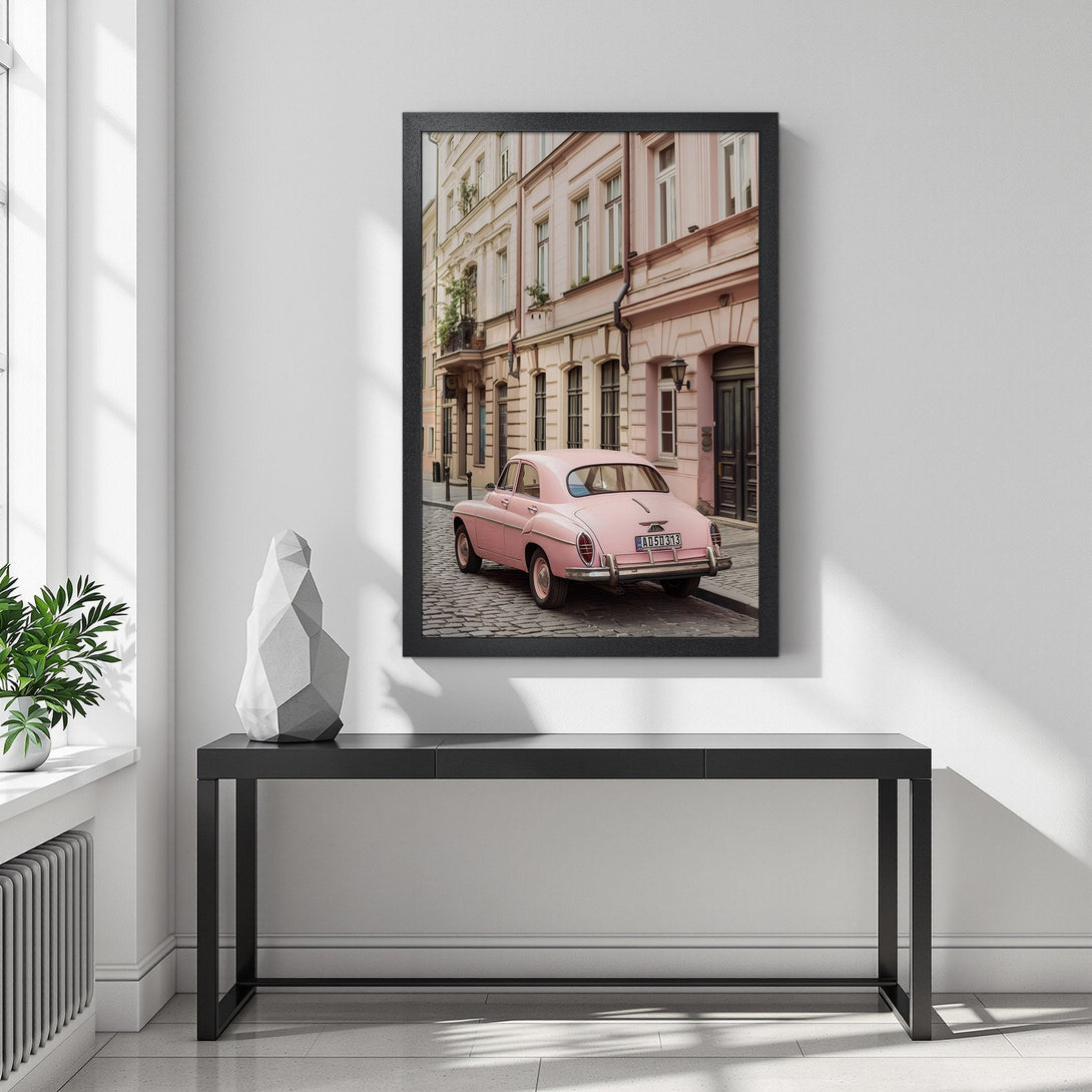 Framed Poster featuring a vintage pink car on a European street. Soft pastel color palette, perfect for adding a touch of retro charm to your space.