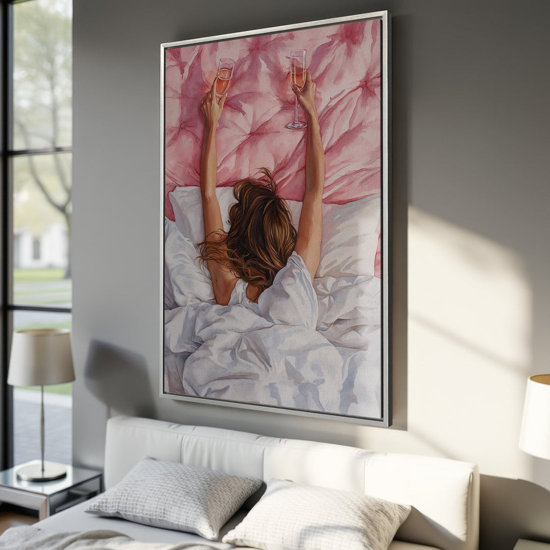 Framed Wall Art: Watercolor painting of a woman in bed toasting with champagne. Soft pink and white color palette, perfect bedroom decor.
