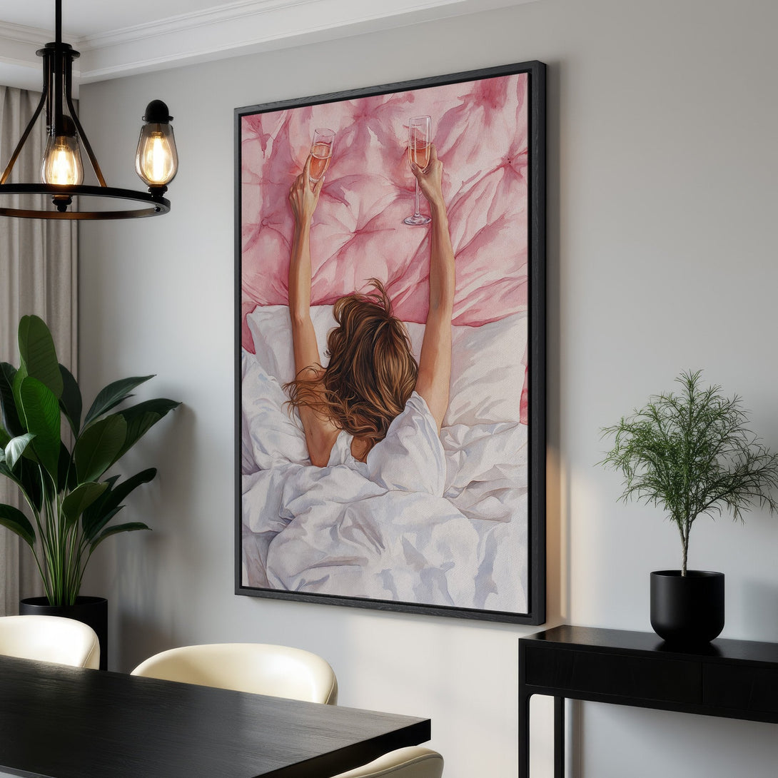 Framed Wall Art: Watercolor painting of a woman in bed, raising champagne glasses. Soft pink and white color palette. Perfect for bedroom decor.