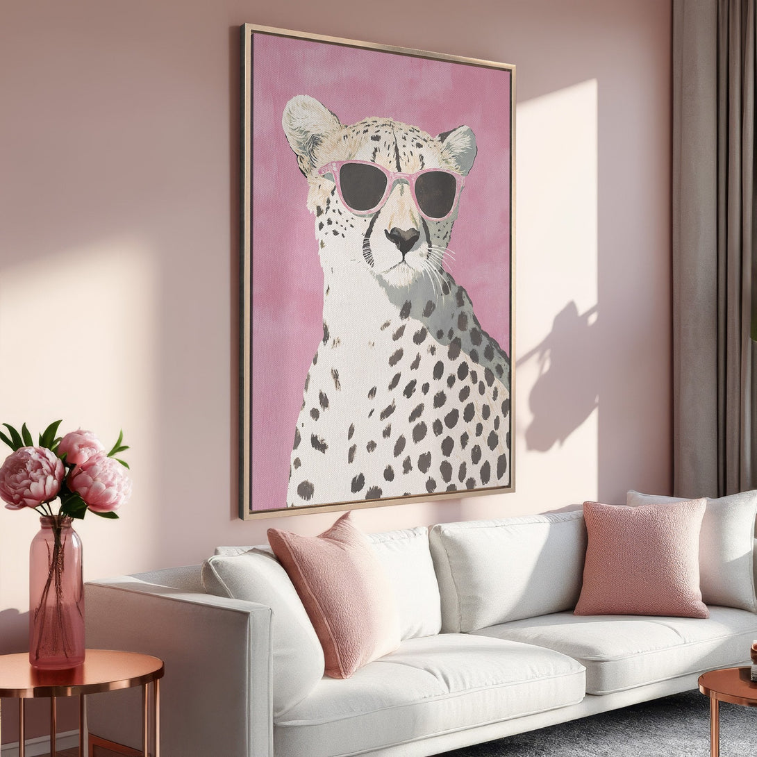 Framed Wall Art: Cool cheetah wearing sunglasses on a pink background, displayed in a stylish interior. Modern art with a blush and neutral color palette.