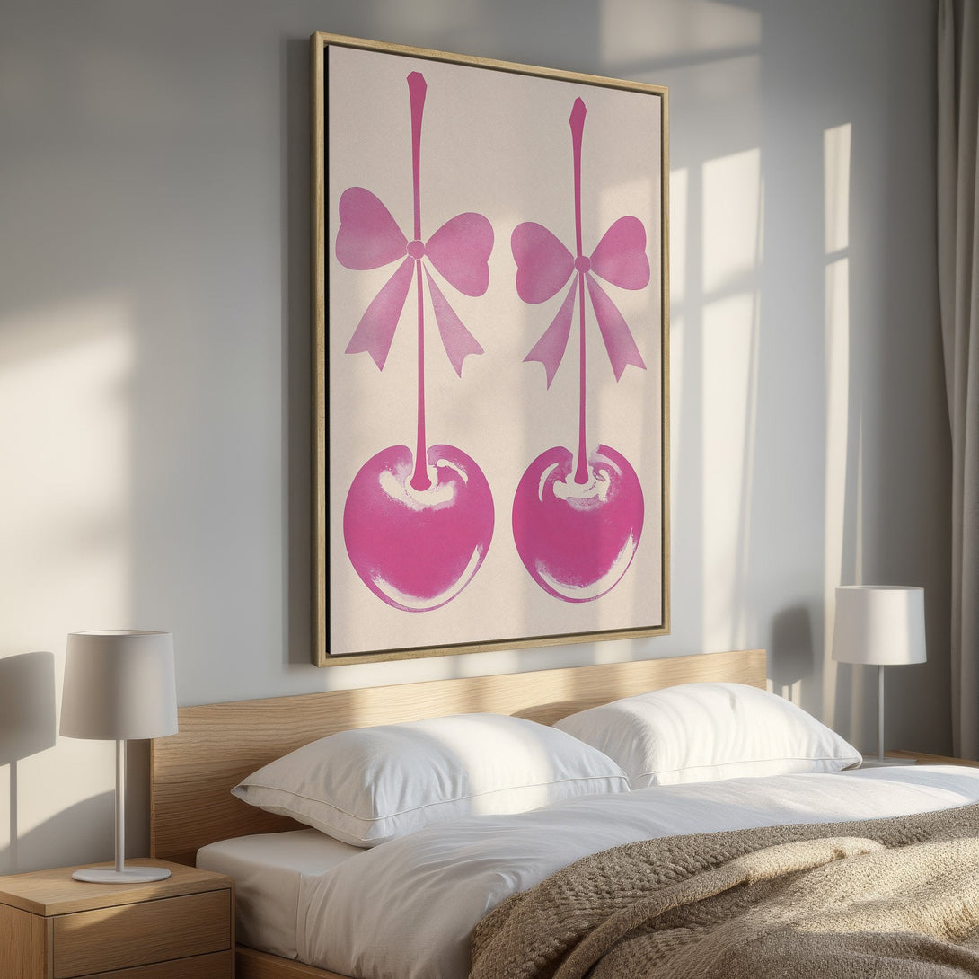 Framed Wall Art: Pop art style canvas print featuring pink cherries with bows, displayed in a bedroom. Adds a touch of playful elegance!
