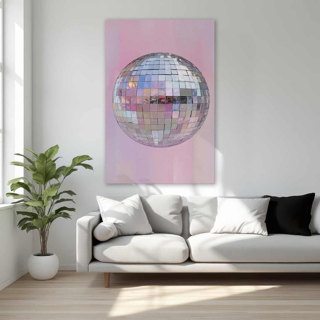 Framed Wall Art featuring a disco ball against a pink backdrop. Adds a touch of glam to any space. Soft, pastel color palette.