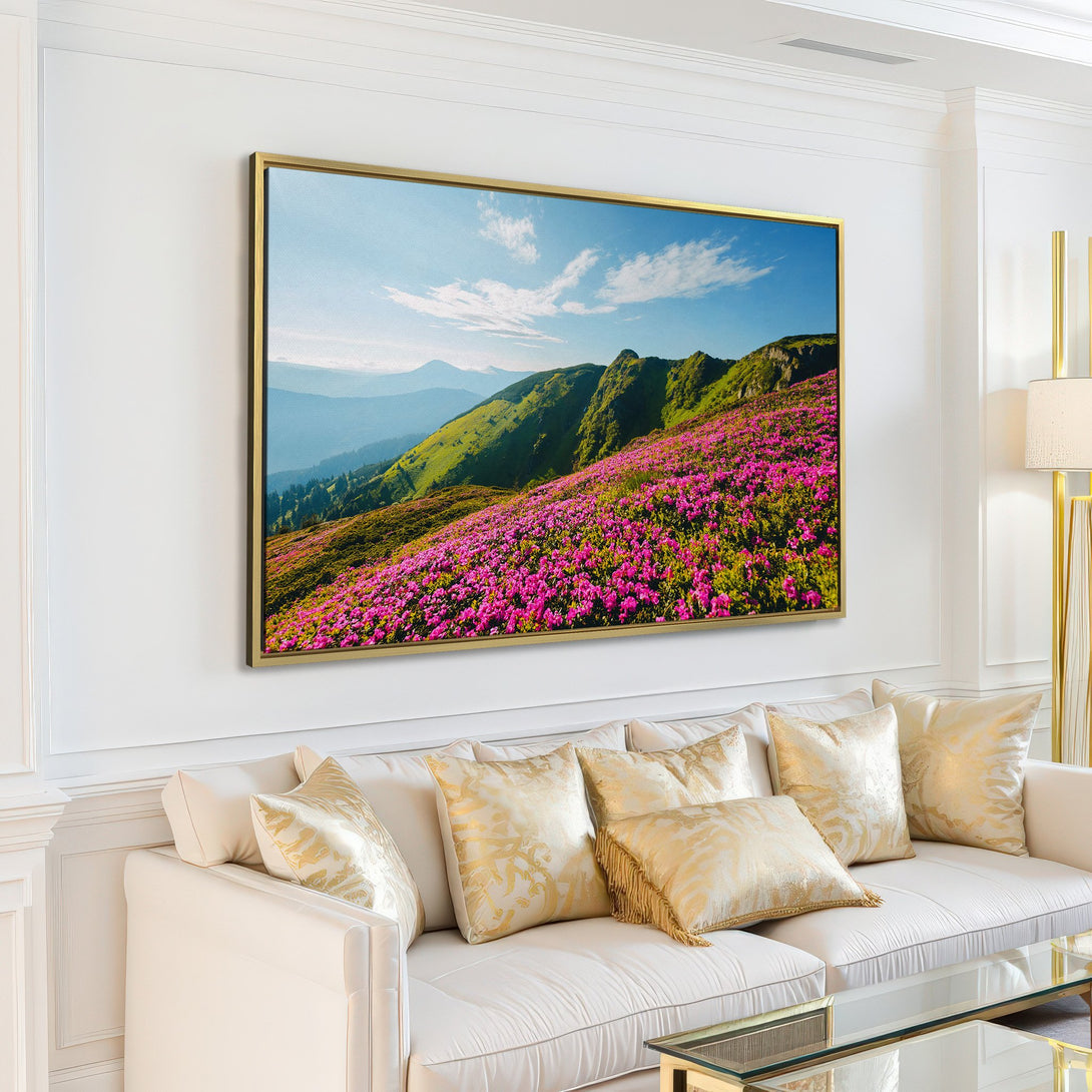 Canvas Print of a mountain landscape with vibrant pink flowers, green hills, and blue sky. Perfect for adding natural beauty to your home.