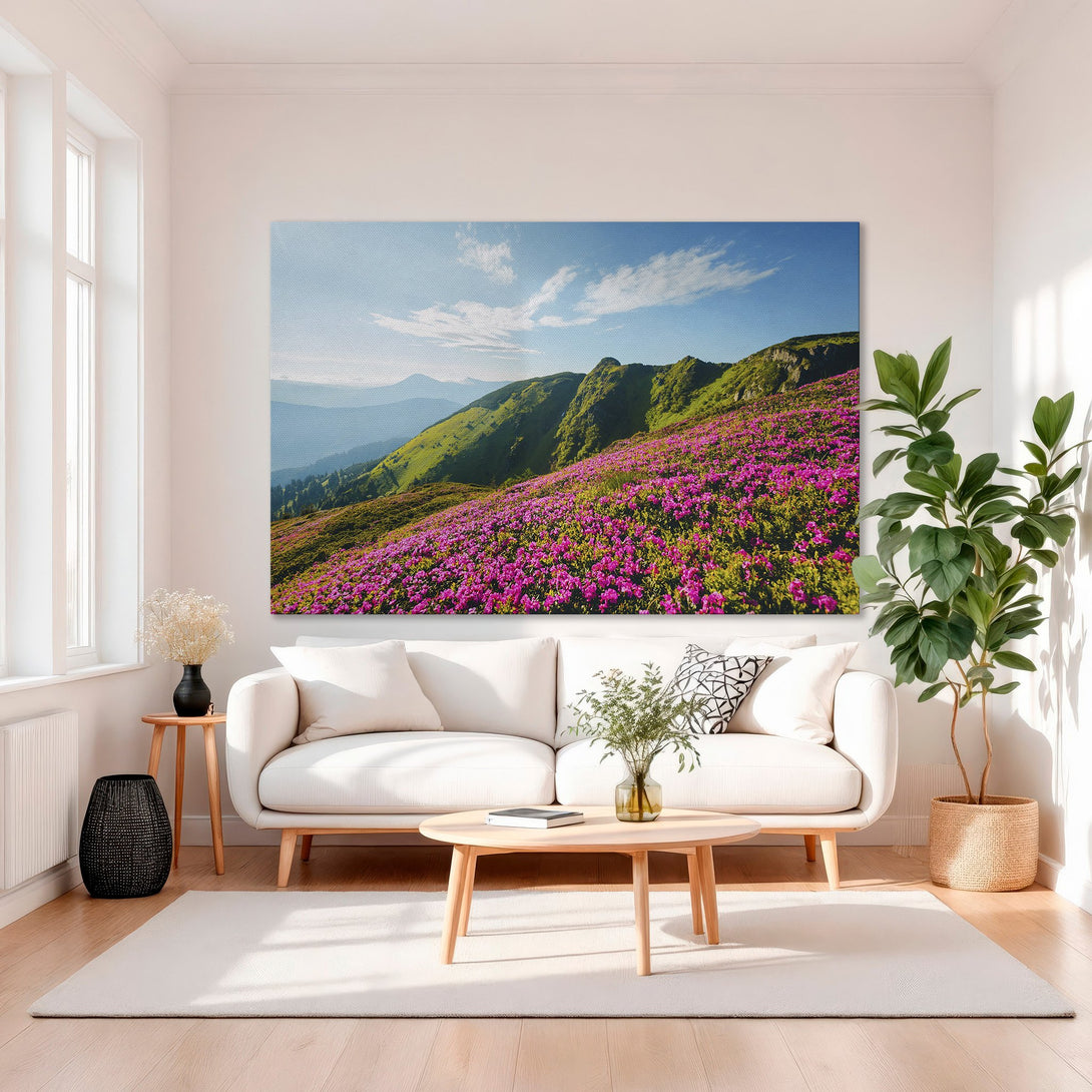 Framed Wall Art: Mountain landscape Canvas Print with vibrant pink flowers and green hills. Adds a pop of color to any room.