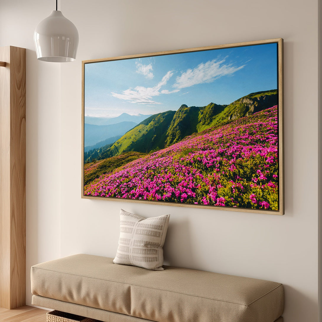 Framed Wall Art featuring a vibrant mountain landscape with pink flowers. Nature-inspired artwork in a modern interior, showcasing a green and pink color palette.