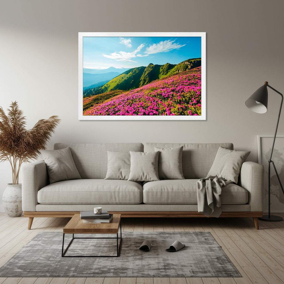 Framed Poster of vibrant mountain landscape with pink flowers, green hills, and blue sky. Nature-inspired art in a modern style.