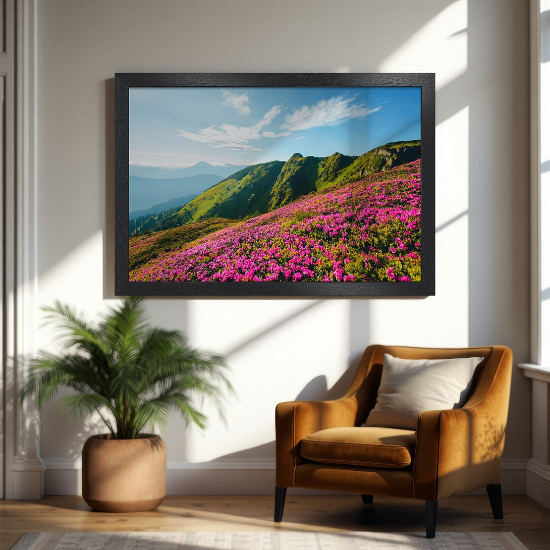 Framed Poster of mountain landscape with pink flowers, green hills, and blue sky. Nature-inspired art in vibrant colors.