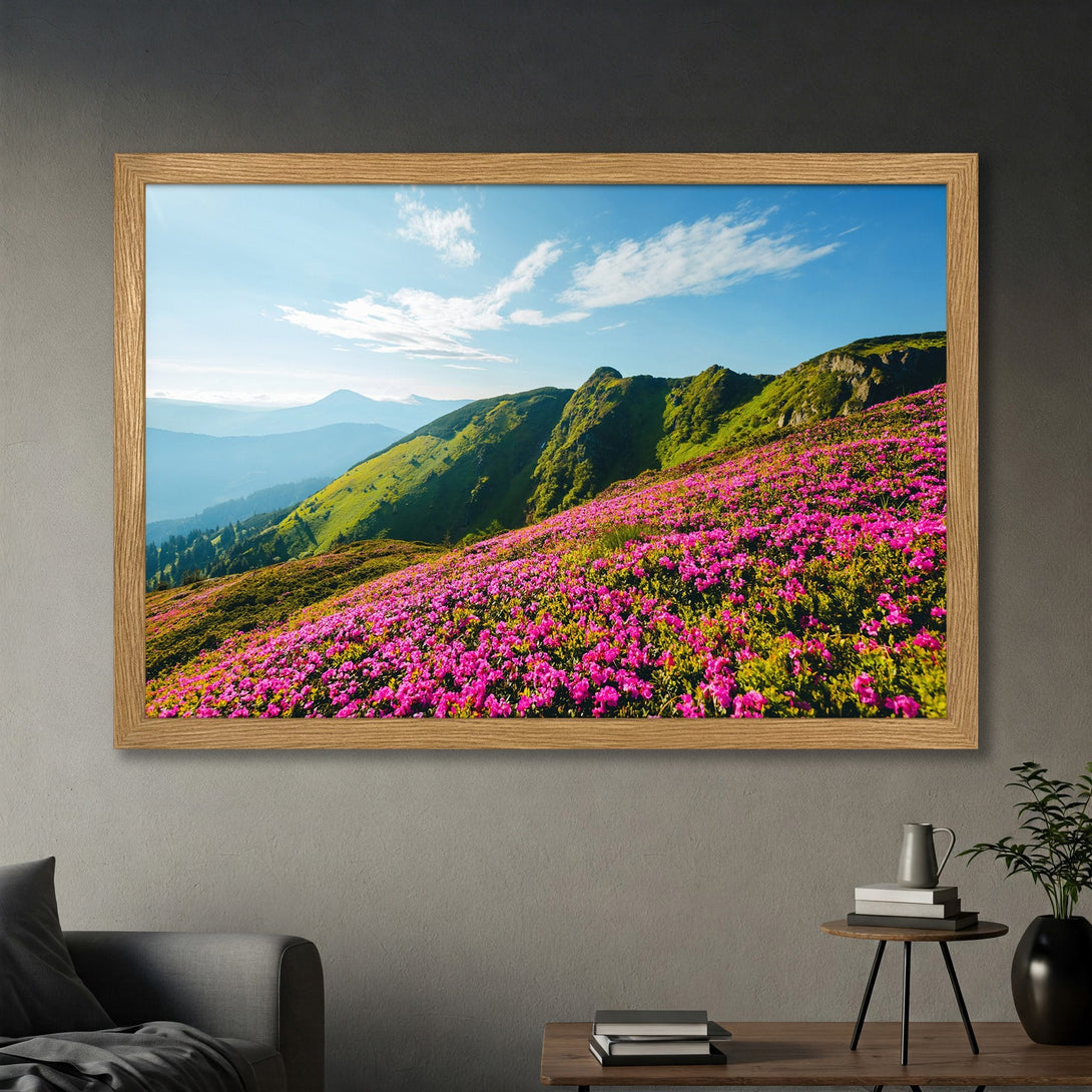 Framed Poster featuring a vibrant mountain landscape with pink flowers, green hills, and blue sky. A beautiful nature-inspired print for your home.