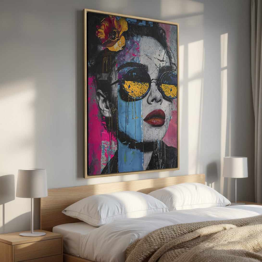 Framed Wall Art: Bold portrait canvas print with a woman wearing sunglasses, vibrant pink, blue, and yellow color palette, perfect for modern bedroom decor.