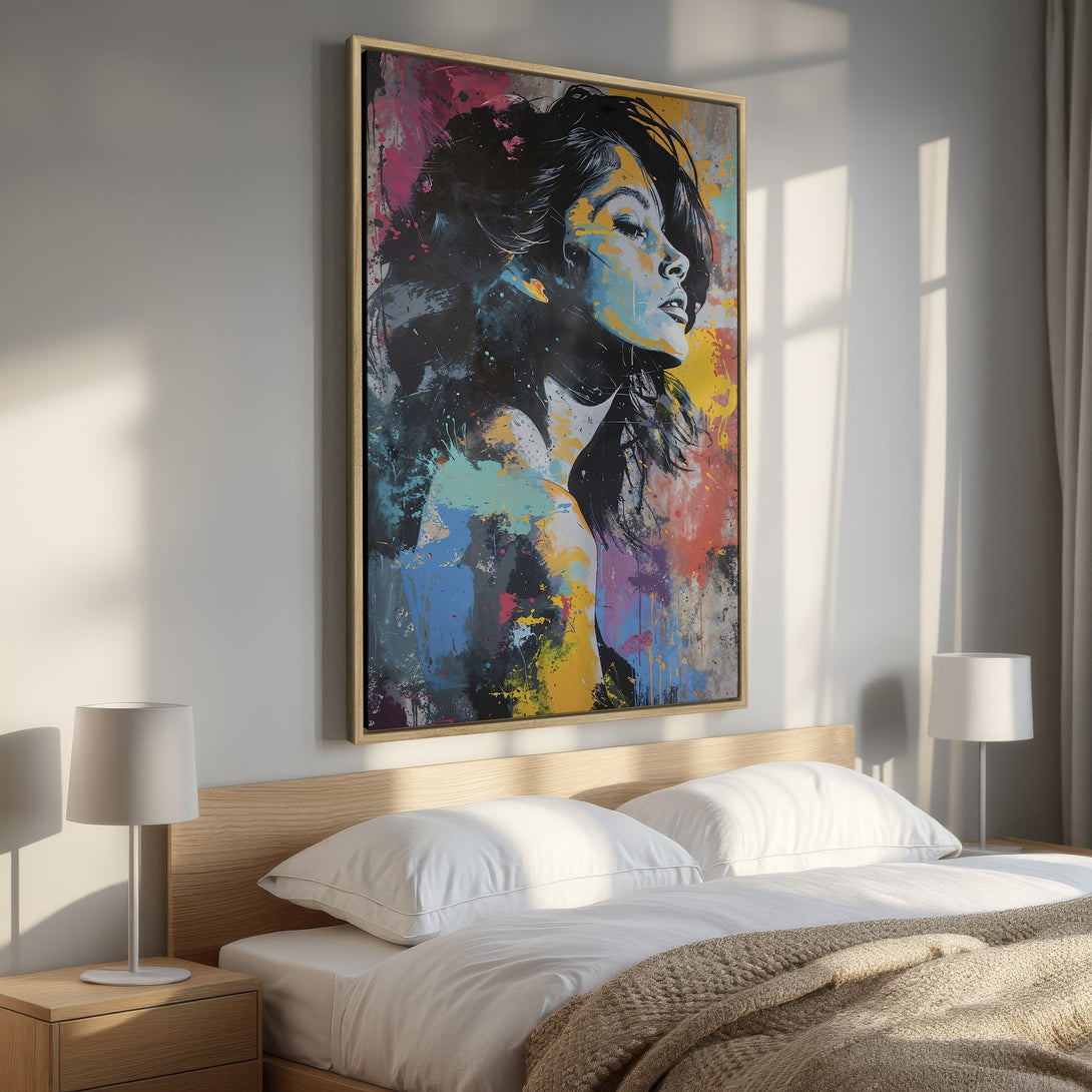 Framed Wall Art: Abstract portrait Canvas Print with a woman's face, vibrant splashes of color in a modern bedroom. Add art to your space!