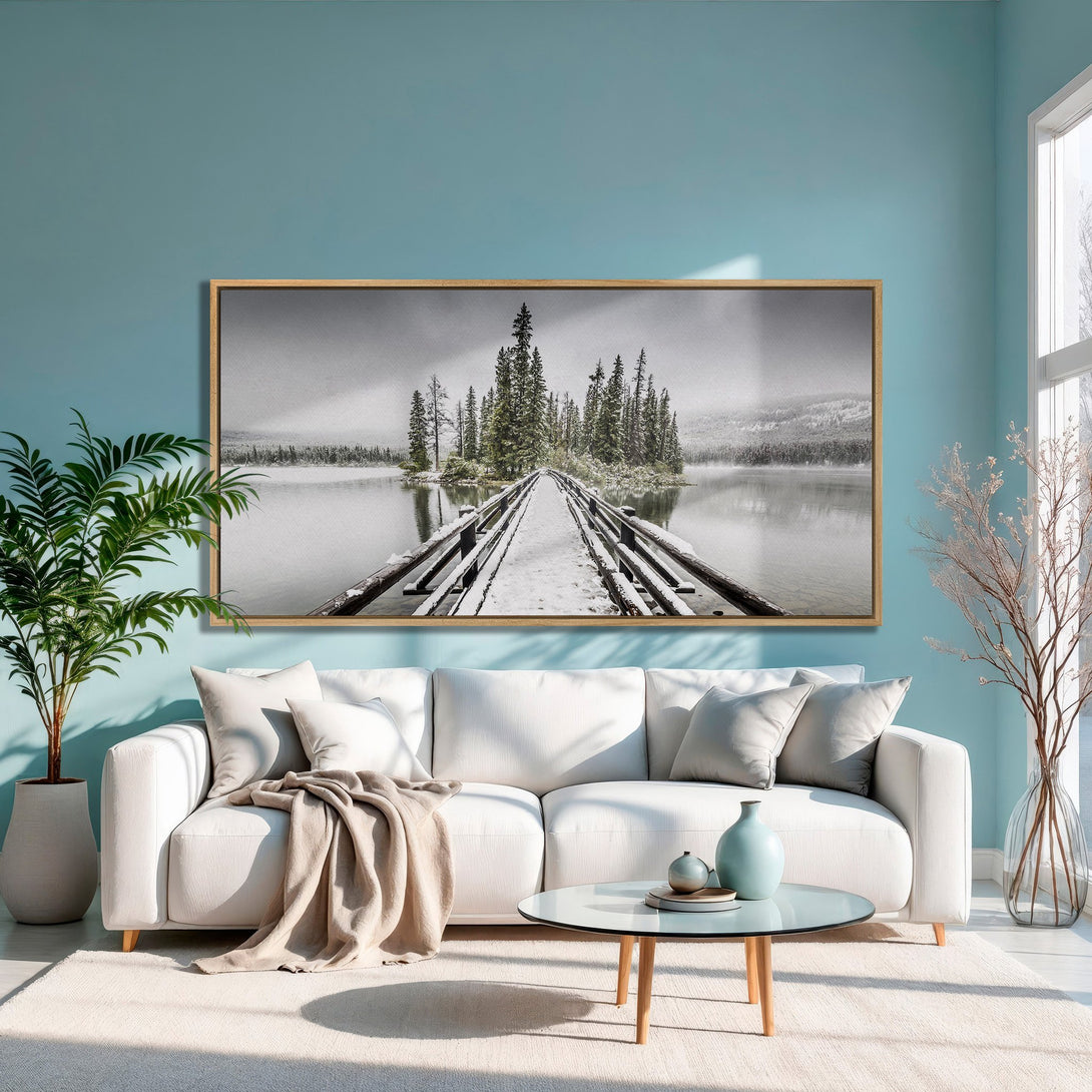 Framed Wall Art: Serene black and white landscape of a snowy bridge over a lake. Neutral tones with a pop of teal, perfect for modern home decor.