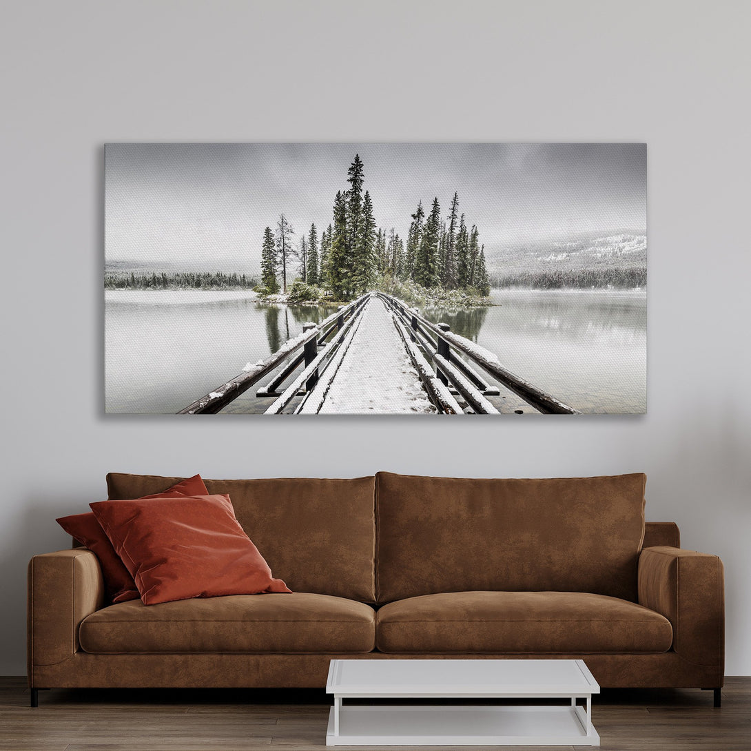 Framed Wall Art featuring a snowy bridge over a lake. Neutral tones and a serene landscape create a calming aesthetic for any room.