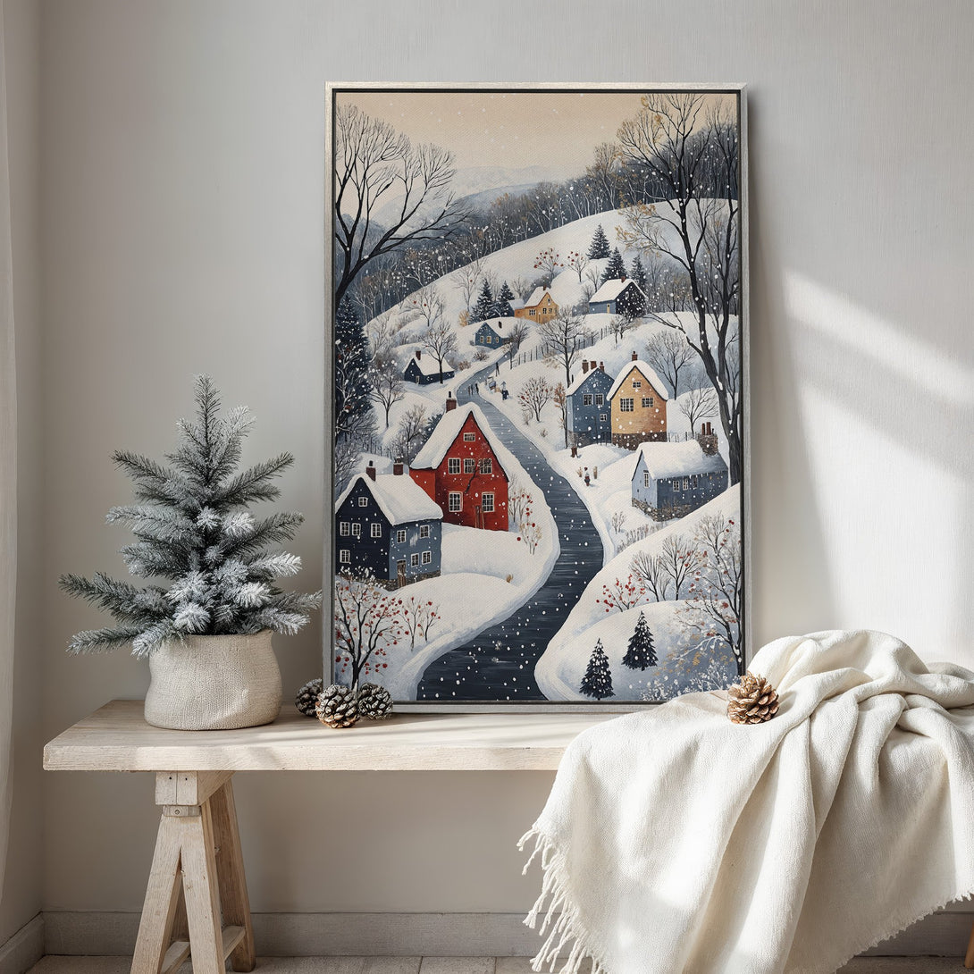 Framed Wall Art: Winter village scene in watercolor style, featuring a snowy landscape with houses. Soft blue, white, and red color palette, perfect for cozy decor.