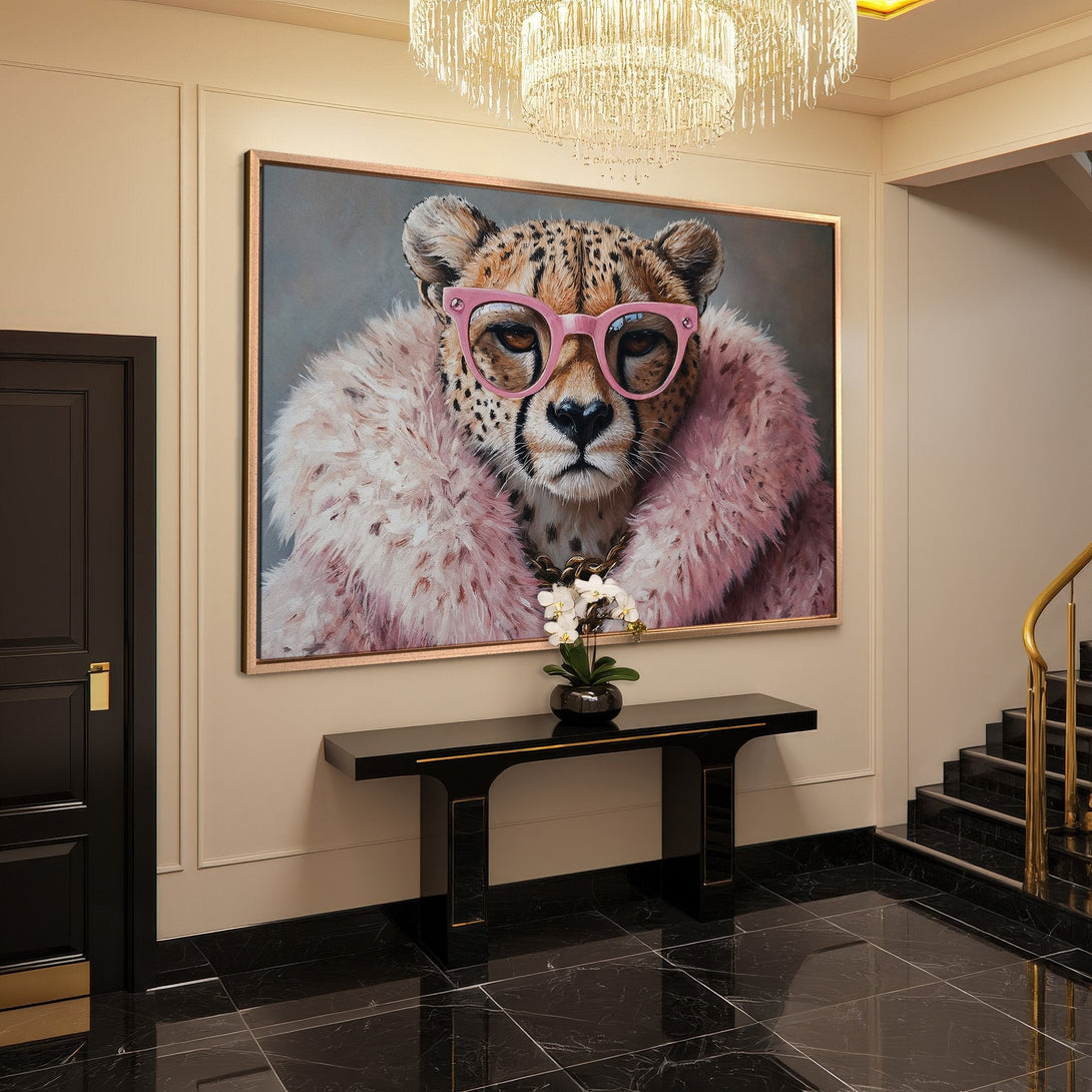 Framed Wall Art featuring a cheetah in pink glasses and fur, perfect for a modern, stylish interior. Pops of pink and neutral tones.