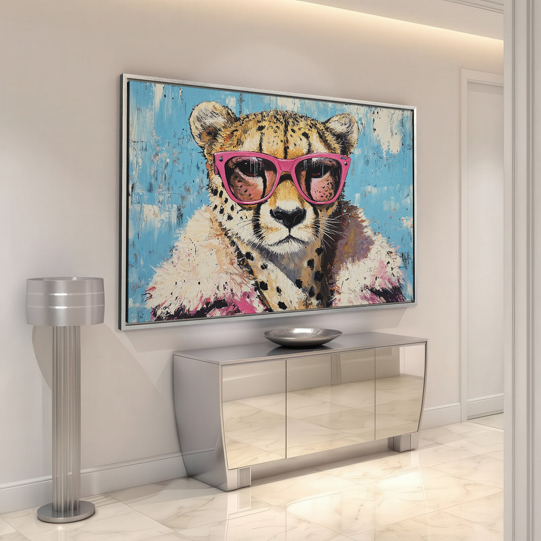 Framed Wall Art of a cool cheetah in pink sunglasses. Modern abstract style with a blue, pink, and neutral color palette. Perfect for adding personality to your space!