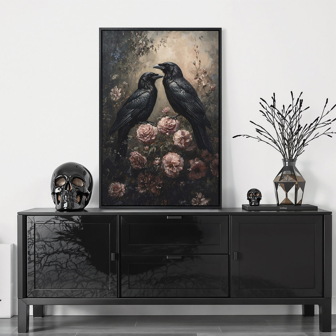 Framed Wall Art featuring two ravens perched on roses, a dark and romantic painting. Moody color palette of black, gray, and blush pink. Elevate your space!
