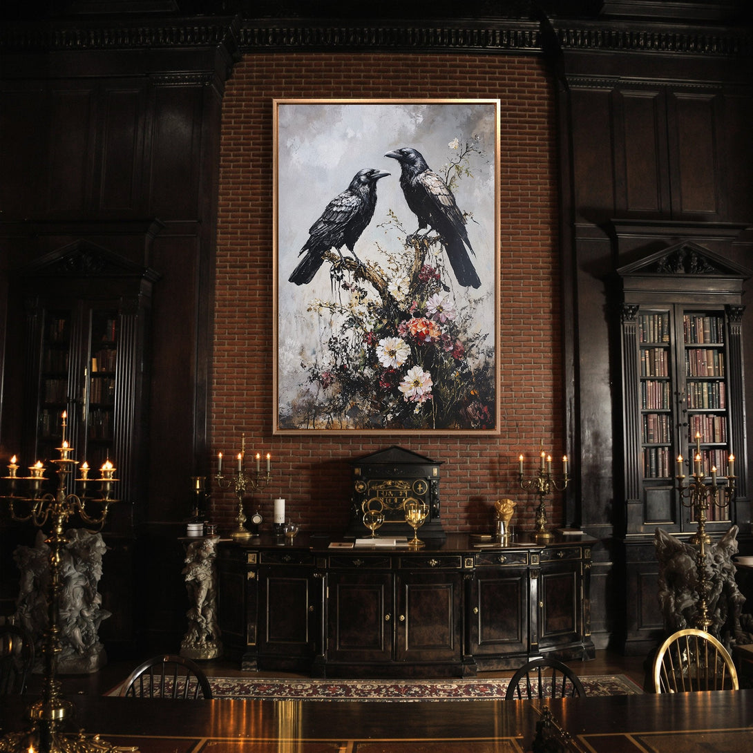 Framed Wall Art featuring two ravens on a branch, displayed in a dark, moody interior. The artwork has a painterly style with a muted, earthy color palette.