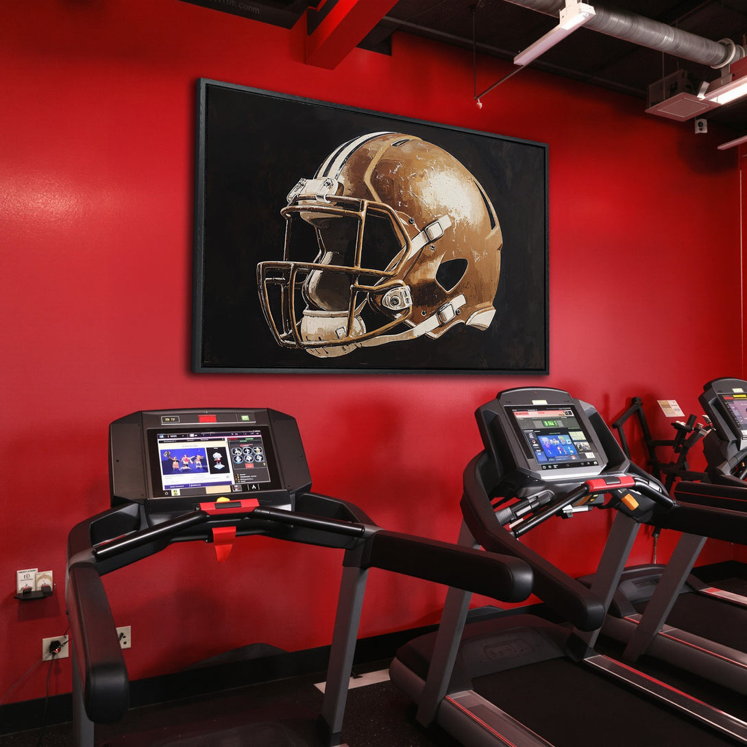 Framed Wall Art of a football helmet in a gym. Modern style, neutral & gold tones against a bold red wall. Elevate your space!
