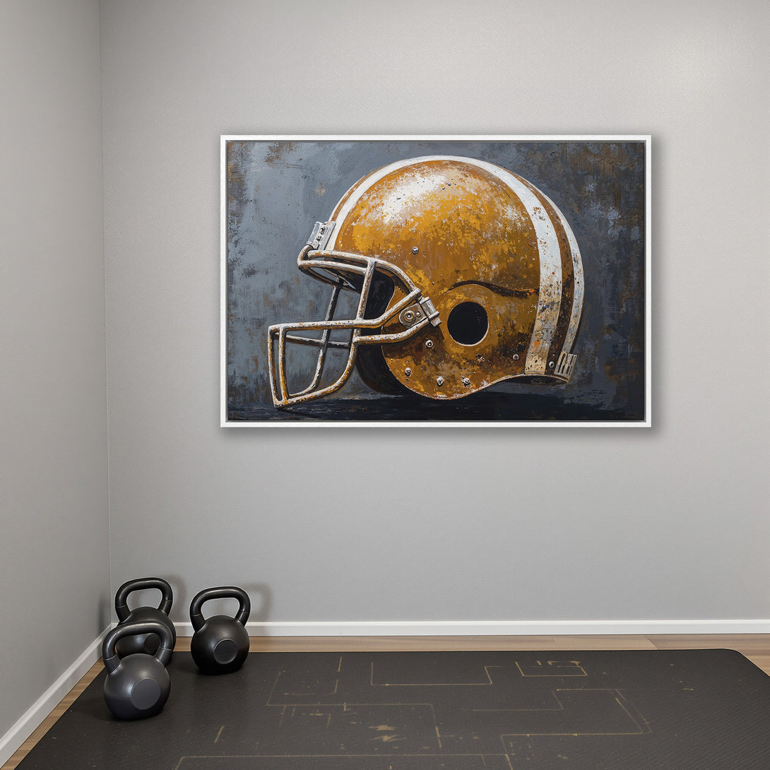 Framed Wall Art: Vintage football helmet art print in a neutral interior. Features a rustic, distressed style with gold, gray, and white tones. Perfect for a gym or home decor.