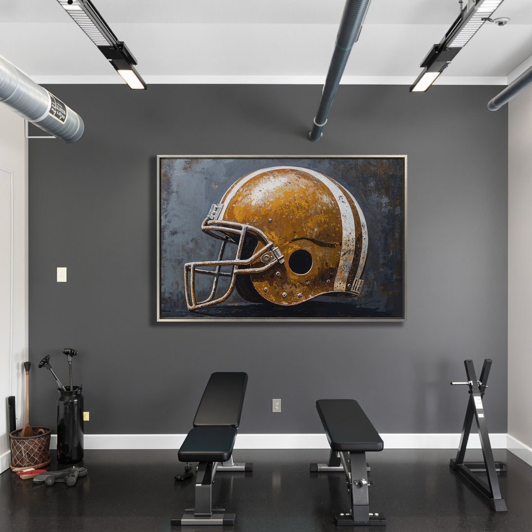 Framed Wall Art: Rustic football helmet canvas print in a modern gym. Features a warm, weathered color palette. Elevate your space with unique wall decor.