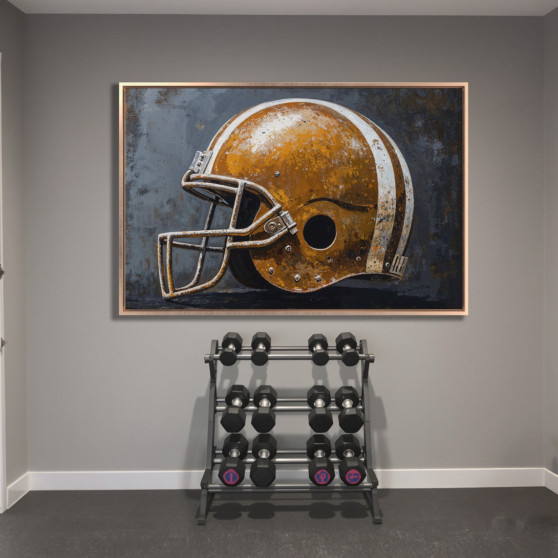 Framed Wall Art: Rustic football helmet art print in a gym. Features a vintage style with a gold, white, and gray color palette. Perfect sports decor.