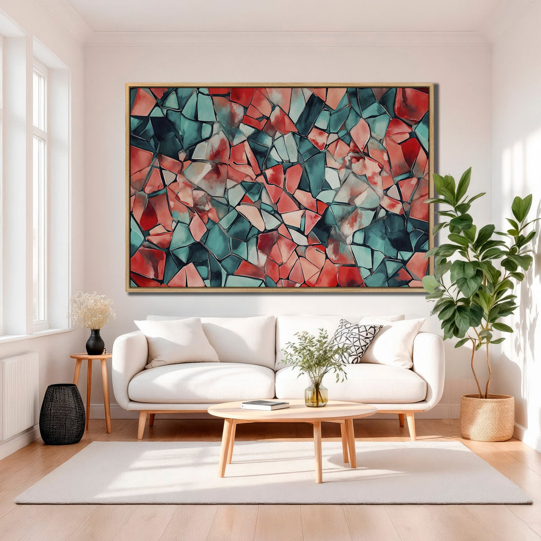 Framed Wall Art featuring an abstract geometric design in teal, red, and coral. Modern Canvas Print adds a pop of color to any living room.