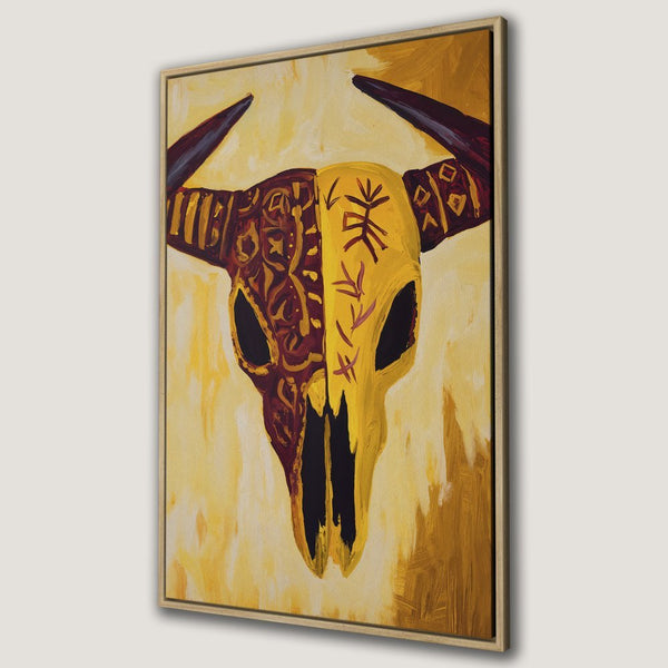 Framed Wall Art: Bold bull skull painting in warm yellow and burgundy tones. Unique, tribal-inspired artwork for your home decor.